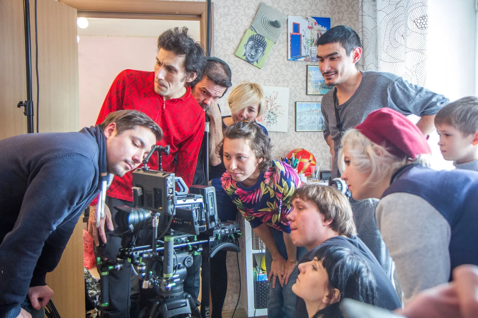 Film crew gathered around a cinema camera during a project led by Julia Sharipova